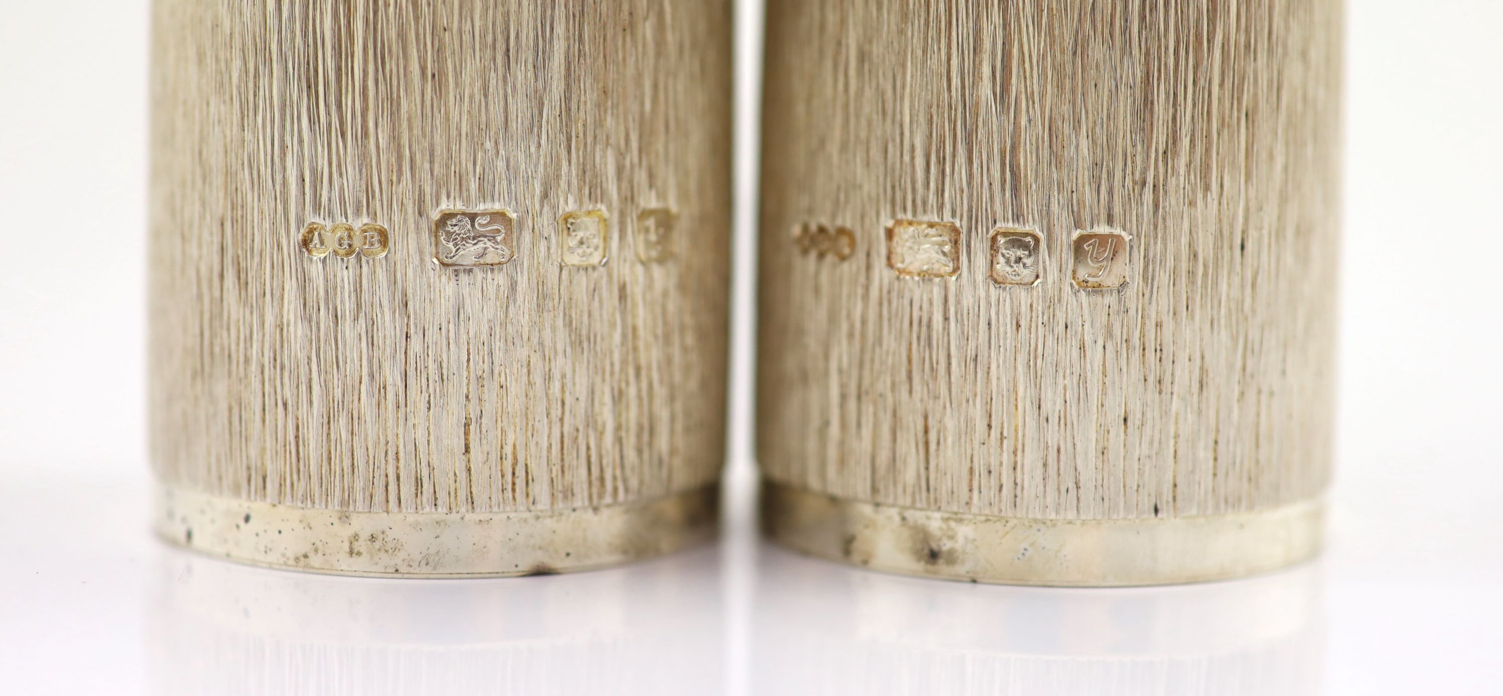 A pair of textured silver salt and pepper mills by Adrian Gerald Benney